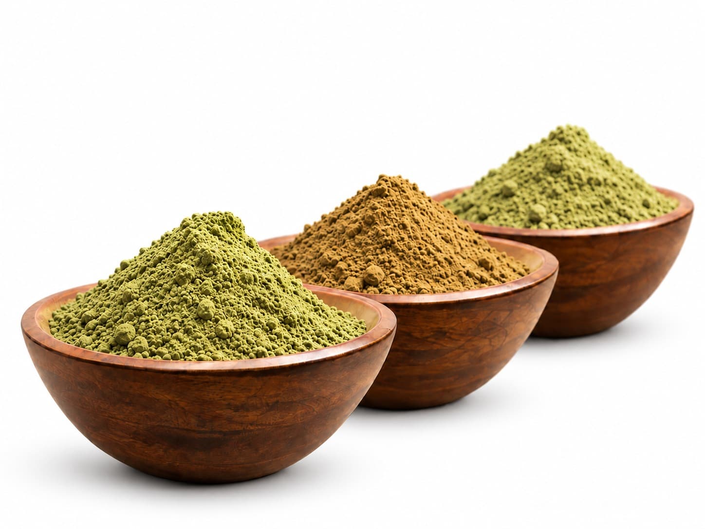 Three wooden bowls of Green, Red, and White kratom powder